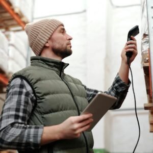 Photo of a Man Scanning Products in a Warehouse