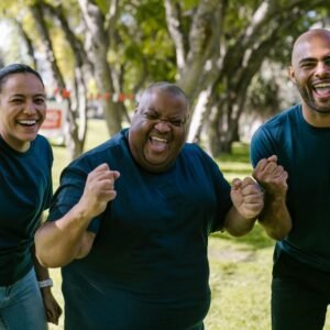 Three People In Blue Crew Neck Shirts With Happy Faces