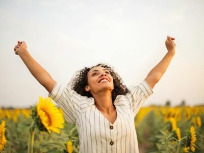 Photo Of Woman Standing On Sunflower Field